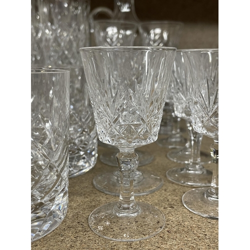 1238 - A QUANTITY OF CUT GLASS ITEMS TO INCLUDE A DECANTER, LARGE JUG, CHAMPAGNE FLUTES, TUMBLERS, SHERRY G... 