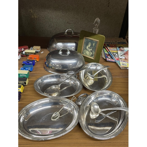 1255 - A QUANTITY OF SILVER PLATED SERVING DISHES AND CLOCHE LIDS TOGETHER WITH LADELS, DECANTER, ETC.,