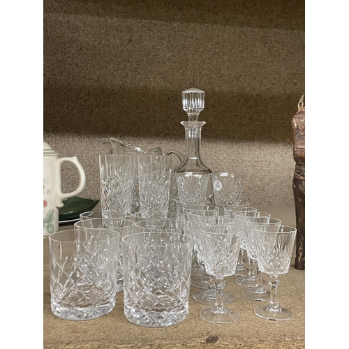 1238 - A QUANTITY OF CUT GLASS ITEMS TO INCLUDE A DECANTER, LARGE JUG, CHAMPAGNE FLUTES, TUMBLERS, SHERRY G... 