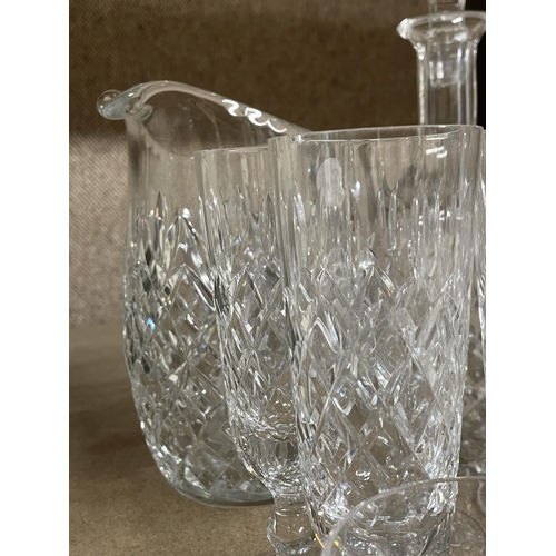 1238 - A QUANTITY OF CUT GLASS ITEMS TO INCLUDE A DECANTER, LARGE JUG, CHAMPAGNE FLUTES, TUMBLERS, SHERRY G... 