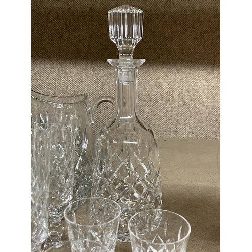 1238 - A QUANTITY OF CUT GLASS ITEMS TO INCLUDE A DECANTER, LARGE JUG, CHAMPAGNE FLUTES, TUMBLERS, SHERRY G... 