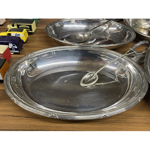 1255 - A QUANTITY OF SILVER PLATED SERVING DISHES AND CLOCHE LIDS TOGETHER WITH LADELS, DECANTER, ETC.,