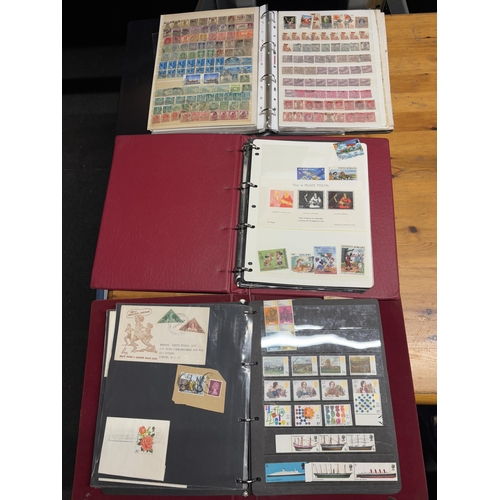 487A - THREE STOCK ALBUMS CONTAINING GB AND WORLD STAMPS