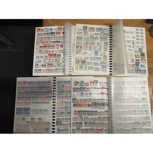 494A - FOUR STOCK ALBUMS CONTAINING GB AND WORLD STAMPS