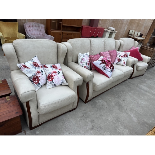 2945 - A CREAM LEATHER THREE PIECE SUITE COMPRISING OF THREE SEATER SETTEE AND TWO EASY CHAIRS