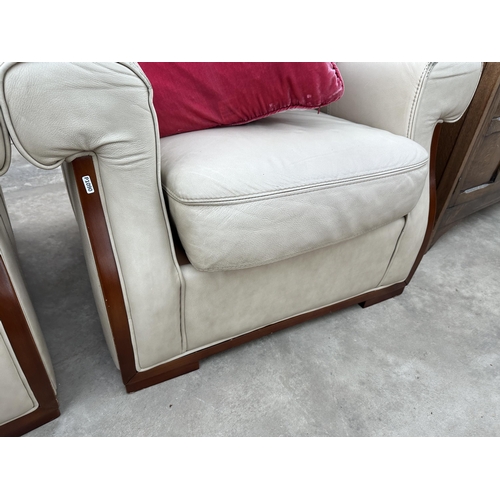 2945 - A CREAM LEATHER THREE PIECE SUITE COMPRISING OF THREE SEATER SETTEE AND TWO EASY CHAIRS