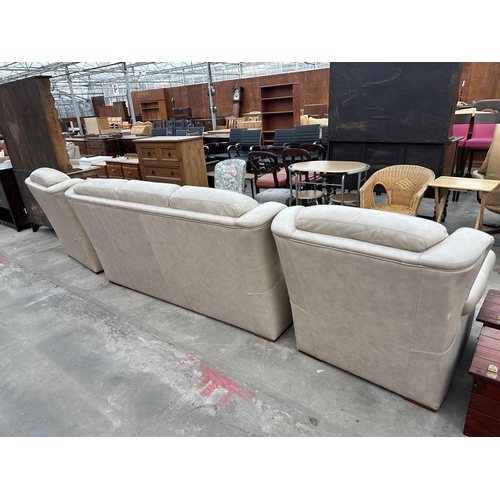 2945 - A CREAM LEATHER THREE PIECE SUITE COMPRISING OF THREE SEATER SETTEE AND TWO EASY CHAIRS