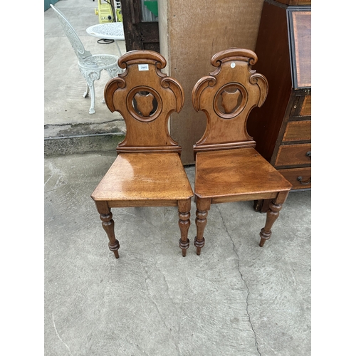 2985 - A PAIR OF VICTORIAN MAHOGANY SHIELD BACK HALL CHAIRS ON TURNED FRONT LEGS