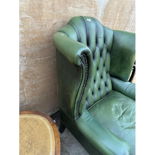 2997 - A GREEN LEATHER WINGED BUTTON BACK FIRESIDE CHAIR ON CABRIOLE LEGS