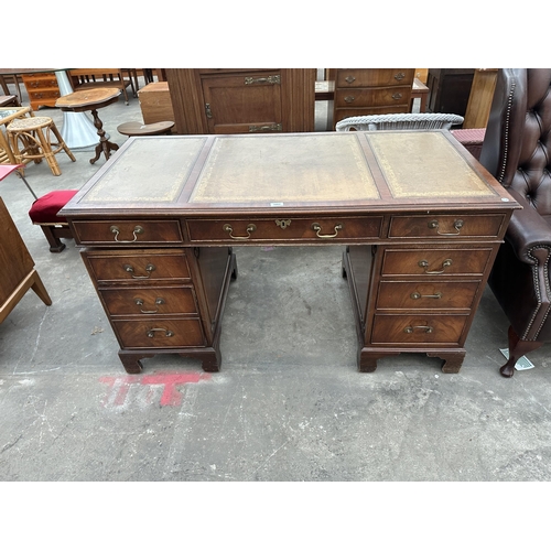 3002 - A MAHOGANY TWIN PEDESTAL DESK ENCLOSING EITGH DRAWERS WITH INSET LEATHER TOP 54