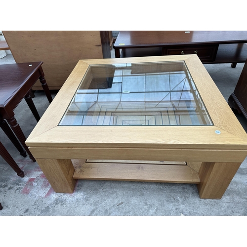 3008 - AN OAK COFFEE TABLE WITH INSET GLASS TOP AND GEOMETRIC DESIGN UNDER TIER 33.5