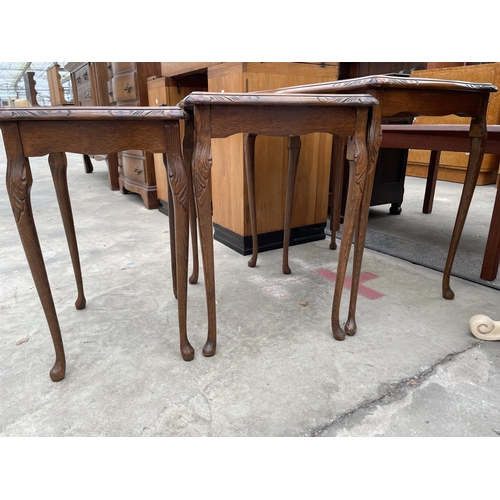 2899 - A MODERN NEST OF THREE WALNUT TABLES ON CABRIOLE LEGS..