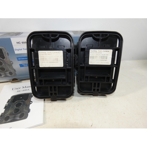 411 - TWO BOXED HC-800A, DIGITAL TRAIL CAMERAS COMPLETE WITH INSTRUCTIONS, BELIEVED TO BE WORKING