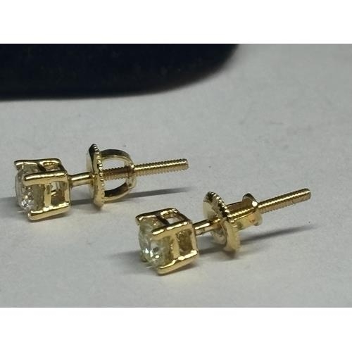 198 - A PAIR OF 14 CARAT YELLOW GOLD SOLITARE DIAMOND STUD EARRINGS TOTAL DIAMOND WEIGHT 0.5 CARATS IN A P... 