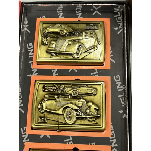 1306 - A BOX SET OF FOUR BRASS LIGHTERS WITH IMAGES OF AMERICAN VINTAGE CARS