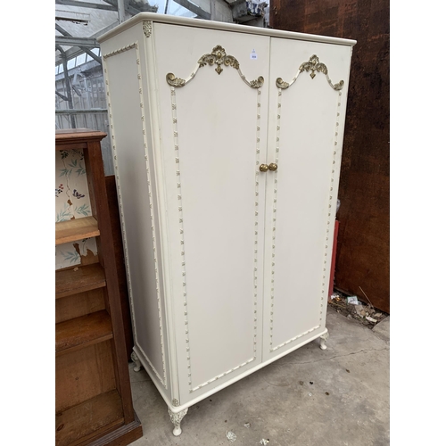 3030 - A CREAM AND GILT TWO DOOR WARDROBE , 45