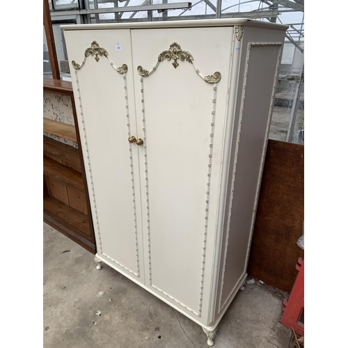 3030 - A CREAM AND GILT TWO DOOR WARDROBE , 45