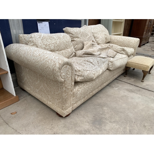 3037 - A THREE SEATER FLORAL SETTEE AND FOOTSTOOL ON CABRIOLE LEGS