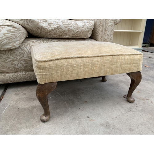 3037 - A THREE SEATER FLORAL SETTEE AND FOOTSTOOL ON CABRIOLE LEGS