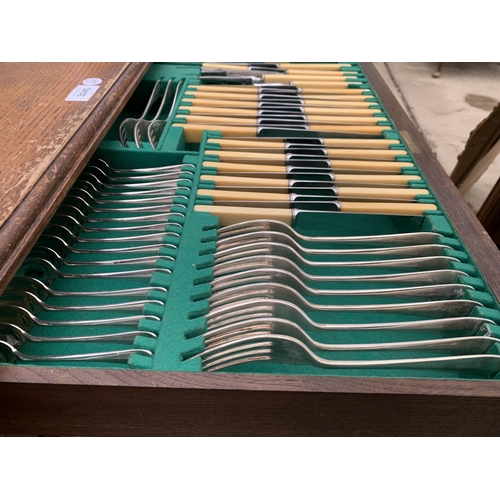 3040 - AN OAK TWO DRAWER CUTLERY CANTEEN BY WALKER AND HALL {COMPLETE WITH CUTLERY}