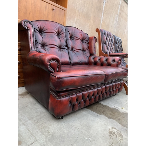 3060 - AN OXBLOOD TWO SEATER SETTEE.