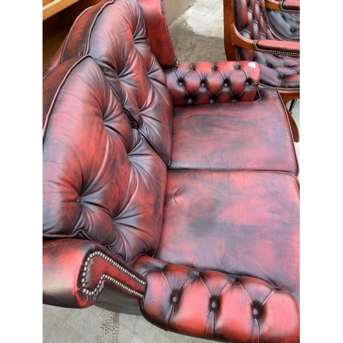 3060 - AN OXBLOOD TWO SEATER SETTEE.