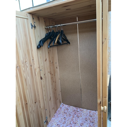 3062 - A PINE TWO DOOR WARDROBE WITH TWO DRAWERS TO BASE, 31