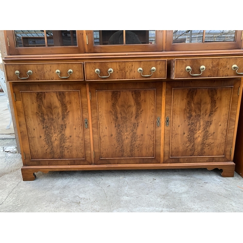 3070 - A YEW WOOD THREE DOOR GLAZED BOOKCASE ON BASE. 59