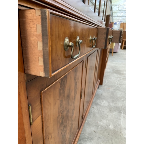 3070 - A YEW WOOD THREE DOOR GLAZED BOOKCASE ON BASE. 59