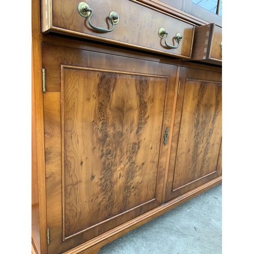 3070 - A YEW WOOD THREE DOOR GLAZED BOOKCASE ON BASE. 59