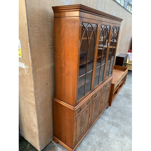 3070 - A YEW WOOD THREE DOOR GLAZED BOOKCASE ON BASE. 59