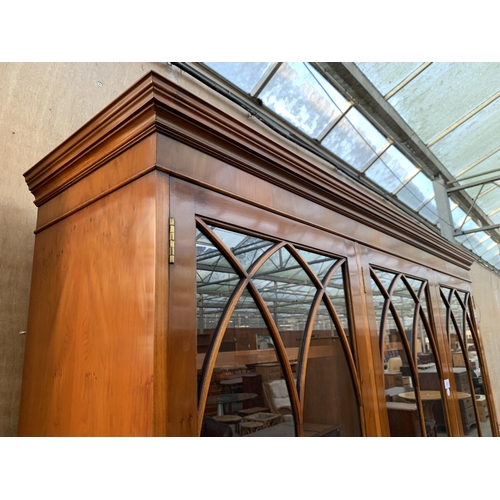 3070 - A YEW WOOD THREE DOOR GLAZED BOOKCASE ON BASE. 59