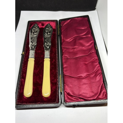 120A - A PAIR OF SILVER PLATED KNIVES IN A PRESENTATION BOX