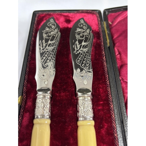 120A - A PAIR OF SILVER PLATED KNIVES IN A PRESENTATION BOX