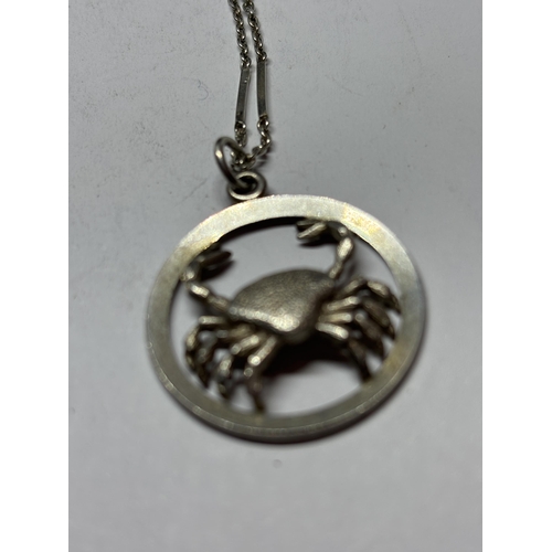 707 - TWO MARKED SILVER NECKLACES TO INCLUDE CRAB AND BIBLE PENDANTS