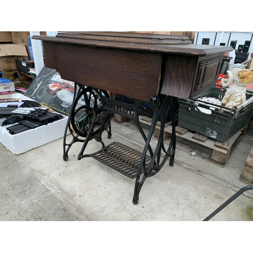 2126 - A VINTAGE JONES TREADLE SEWING MACHINE WITH CAST IRON BASE AND CABINETY