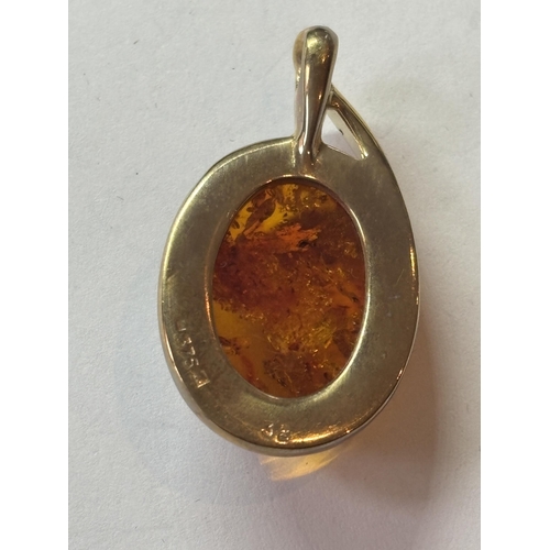 514 - A 9 CARAT GOLD AND AMBER PENDANT IN A PRESENTATION BOX