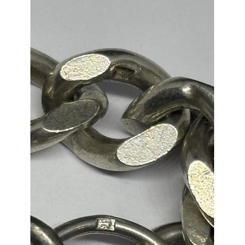 520 - A HALLMARKED BIRMINGHAM SILVER HEAVY WRIST CHAIN WITH HEART PADLOCK EACH LINK MARKED