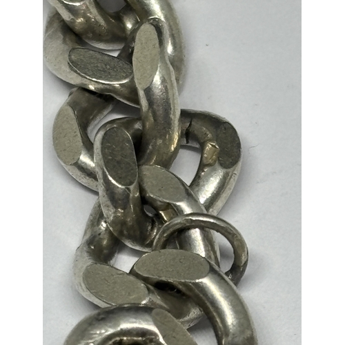 520 - A HALLMARKED BIRMINGHAM SILVER HEAVY WRIST CHAIN WITH HEART PADLOCK EACH LINK MARKED