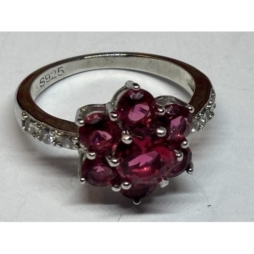 534 - A SILVER RED STONE CLUSTER DRESS RING IN A PRESENTATION BOX