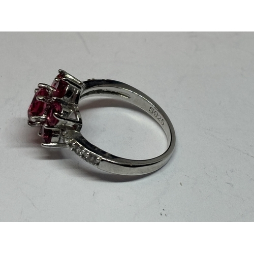 534 - A SILVER RED STONE CLUSTER DRESS RING IN A PRESENTATION BOX