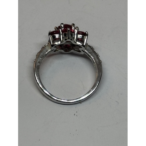 534 - A SILVER RED STONE CLUSTER DRESS RING IN A PRESENTATION BOX