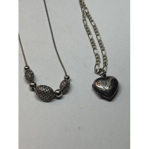 549 - FOUR SILVER NECKLACES WITH PENDANTS