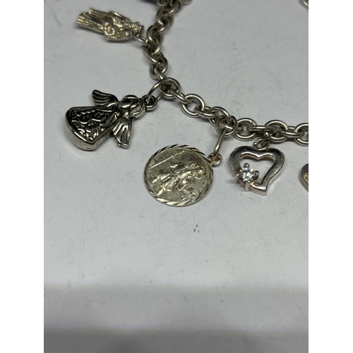 567 - A SILVER CHARM BRACELET WITH FOURTEEN CHARMS