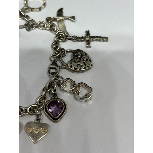 567 - A SILVER CHARM BRACELET WITH FOURTEEN CHARMS