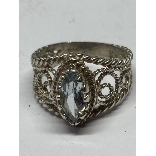 581 - A LADIES SILVER AND BLUE TOPAZ DRESS RING IN A PRESENTATION BOX