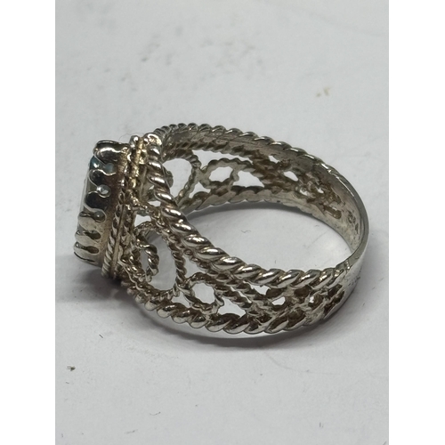 581 - A LADIES SILVER AND BLUE TOPAZ DRESS RING IN A PRESENTATION BOX