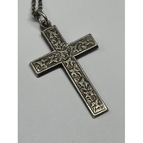 599 - TWO SILVER NECKLACES ONE WITH A CROSS THE OTHER WITH A LOCKET