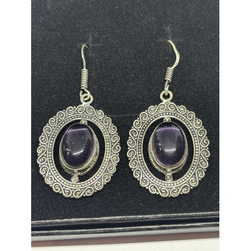 640 - A APAIR OF MARKED 925 SILVER EARRINGS WITH PURPLE STONES IN A PRESENTATION BOX