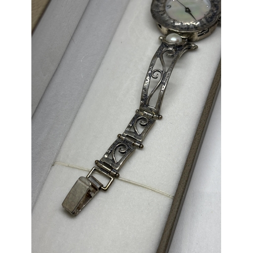 649 - A MARKED SILVER AND MOTHER OF PEARL WATCH IN A PRESENTATION BOX